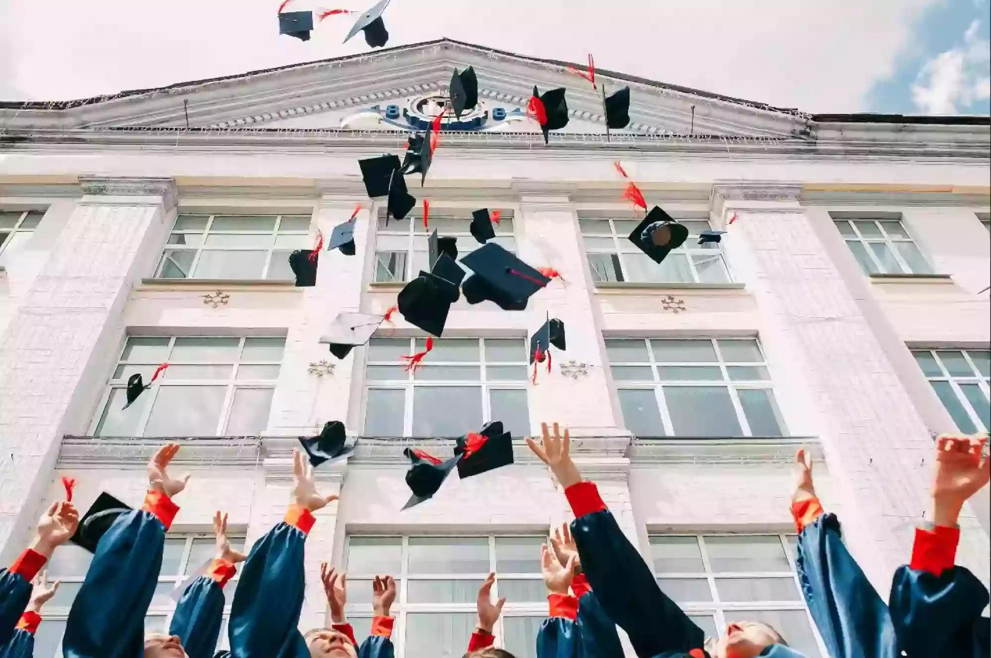 students holding cap